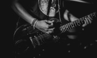 Guitarrista tocando rock para transar numa imagem a preto e branco.